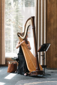 Harpist playing at a ceremony at The Malcolm hotel, Canmore