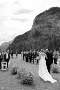 bride and her dad walking down the aisle at a Tunnel Mountain ceremony